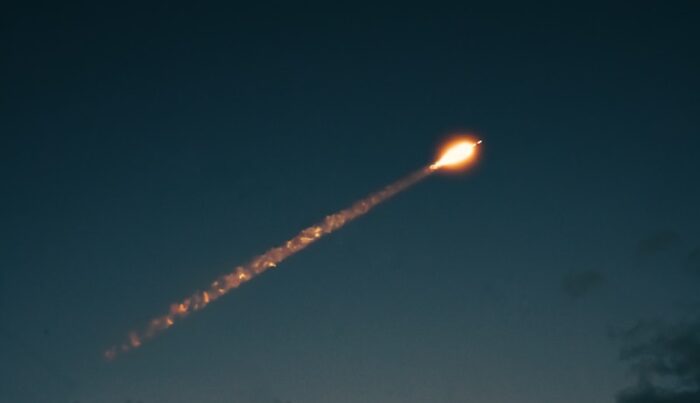 a rocket flying over the ocean